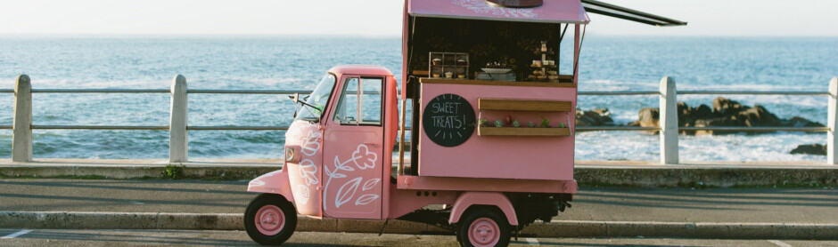 pink food truck by the sea