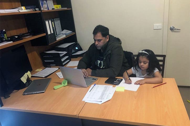 Muaaz and his daughter at work
