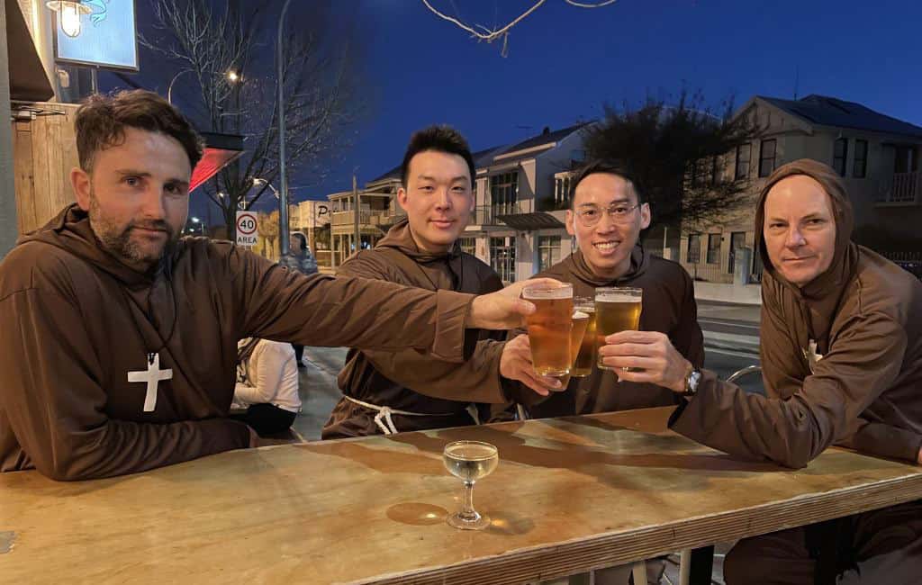 4 monks drinking beer