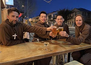 4 monks drinking beer